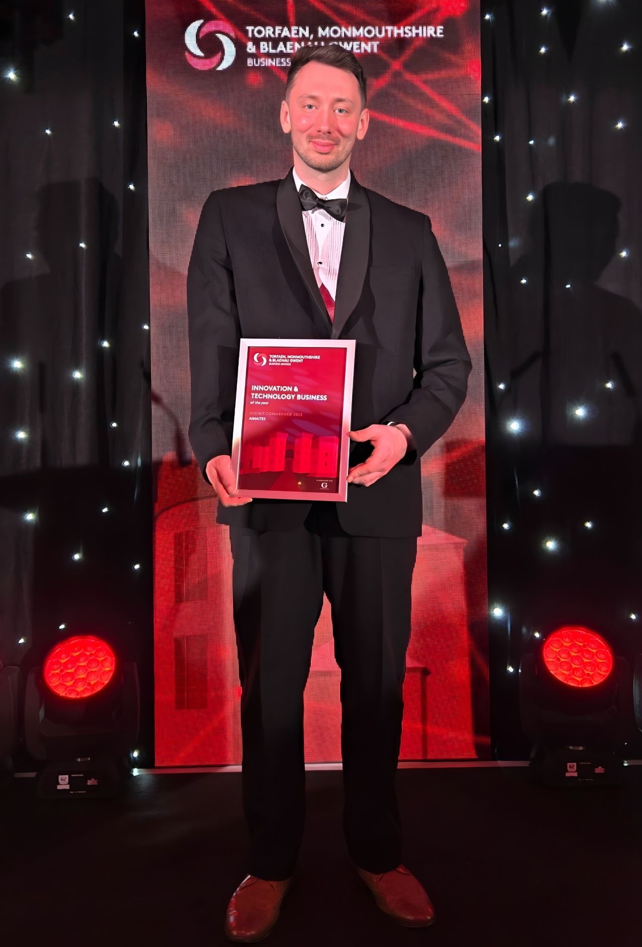 Sion Brown of AIMAITES holding a Highly Commended Innovation and Technology Business award